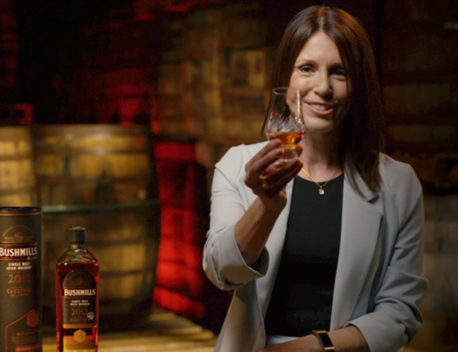 Alex Thomas holding a glass of whisky