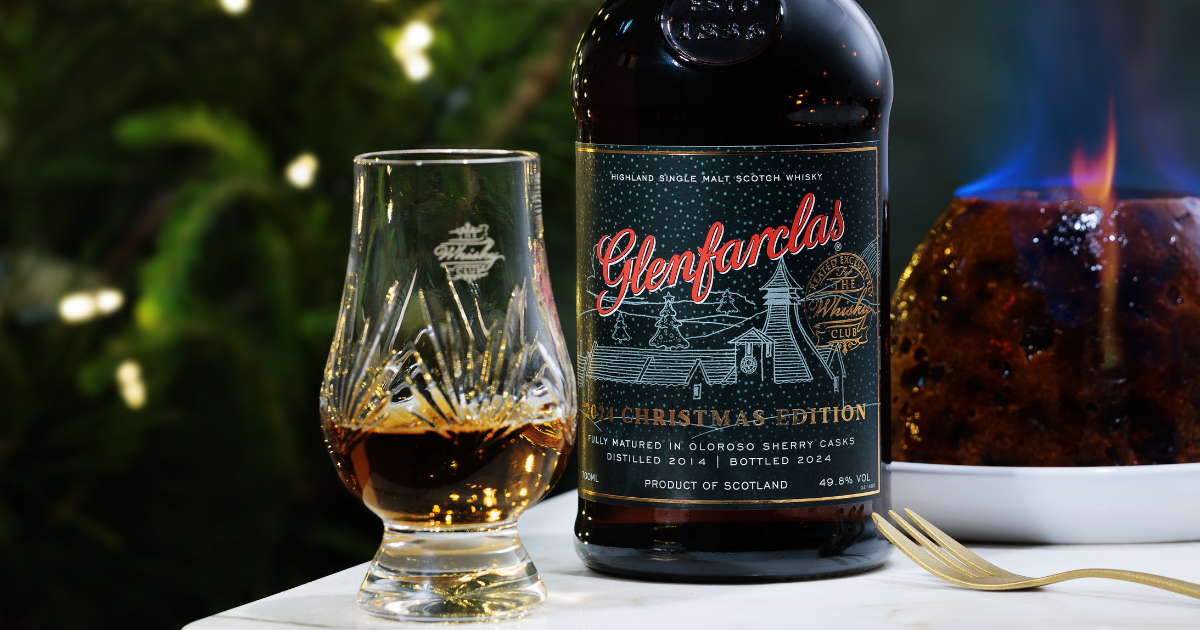 A bottle of Glenfarclas whisky, a Glencairn and a Christmas pudding